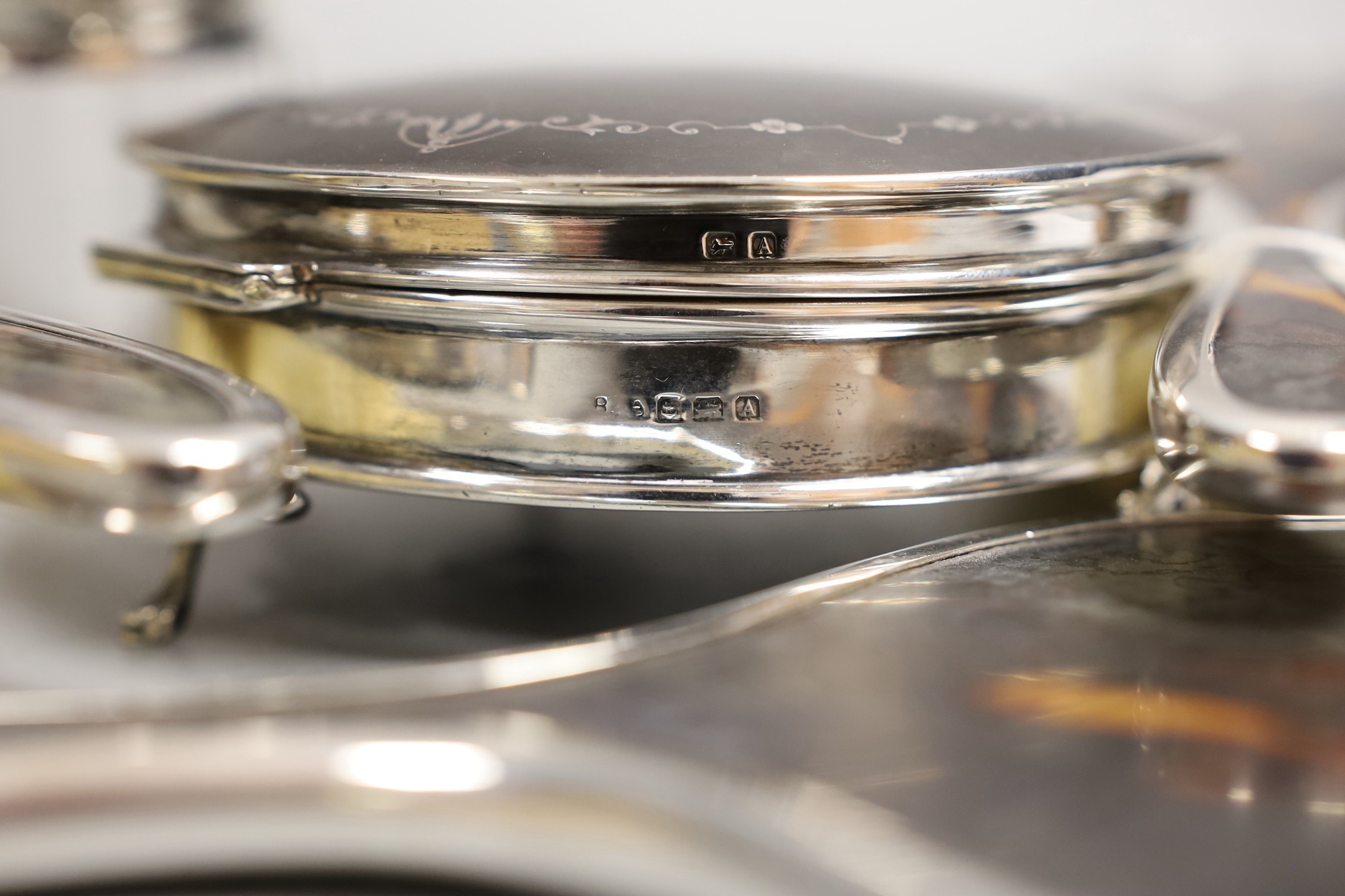A matched George V seven piece silver and tortoiseshell pique mounted mirror, brush, toilet jar and trinket box set, marks rubbed, trinket box Birmingham, 1925, 12.4cm.